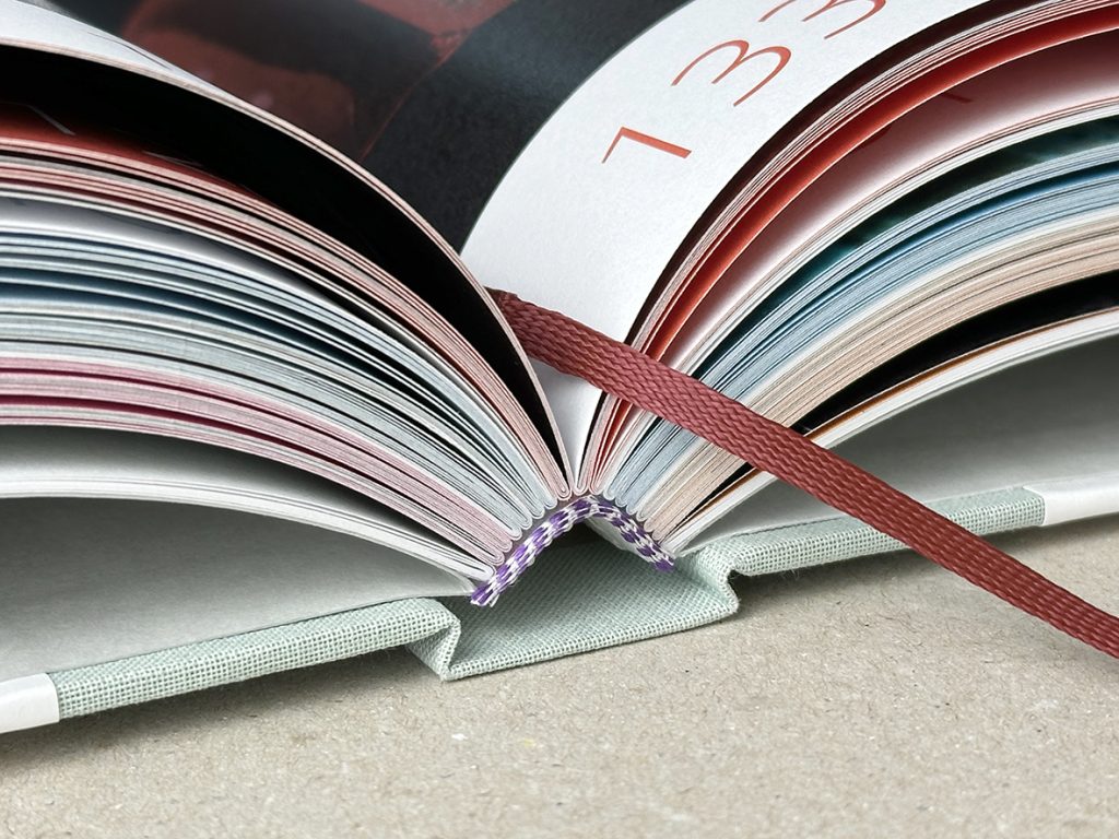 Open boek met rode bladwijzer en paginanummers.